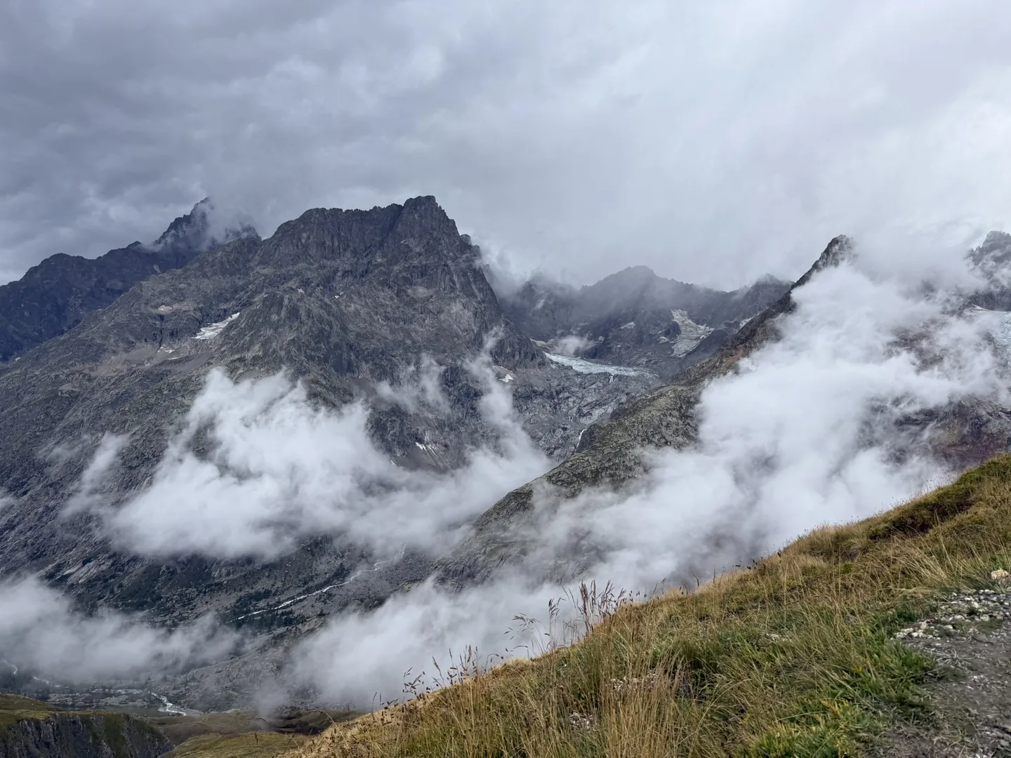 Cloud pouring over rock and glacier on the Mont Blanc massif.